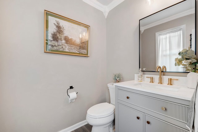 bathroom featuring ornamental molding, toilet, hardwood / wood-style floors, and vanity