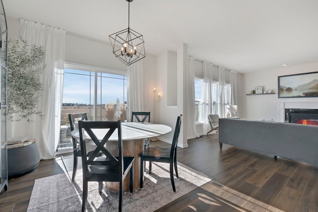 dining area with dark hardwood / wood-style floors and a chandelier