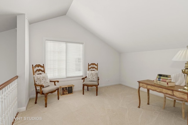 sitting room featuring light carpet and vaulted ceiling