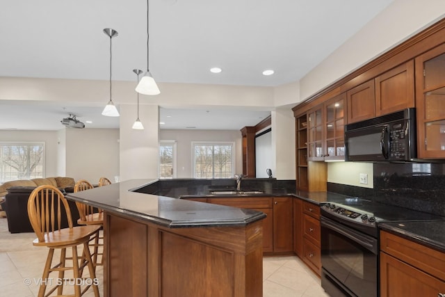 kitchen featuring light tile patterned flooring, sink, hanging light fixtures, kitchen peninsula, and black appliances