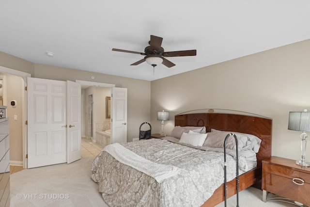 tiled bedroom with connected bathroom and ceiling fan