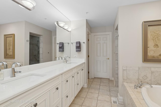 bathroom with vanity, plus walk in shower, and tile patterned flooring