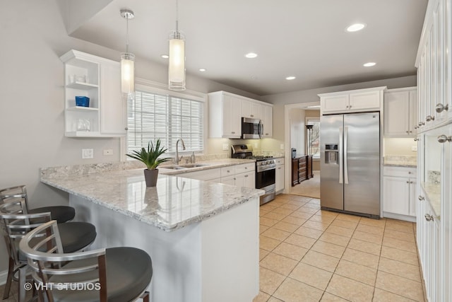 kitchen featuring sink, hanging light fixtures, white cabinets, and appliances with stainless steel finishes