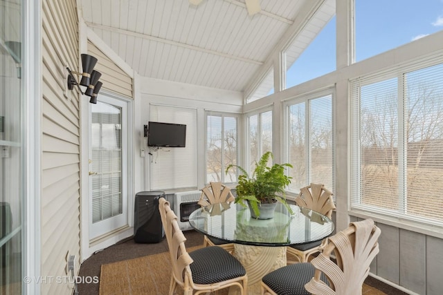 sunroom with a wealth of natural light and vaulted ceiling with beams