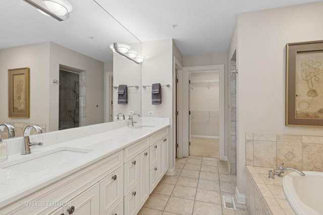 bathroom featuring tile patterned flooring, vanity, and separate shower and tub