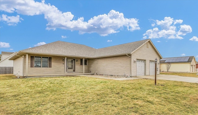 ranch-style house featuring concrete driveway, an attached garage, and a front yard