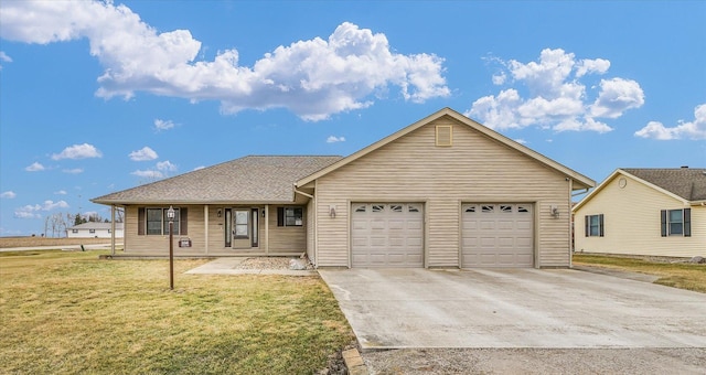 single story home with a front lawn, an attached garage, and driveway