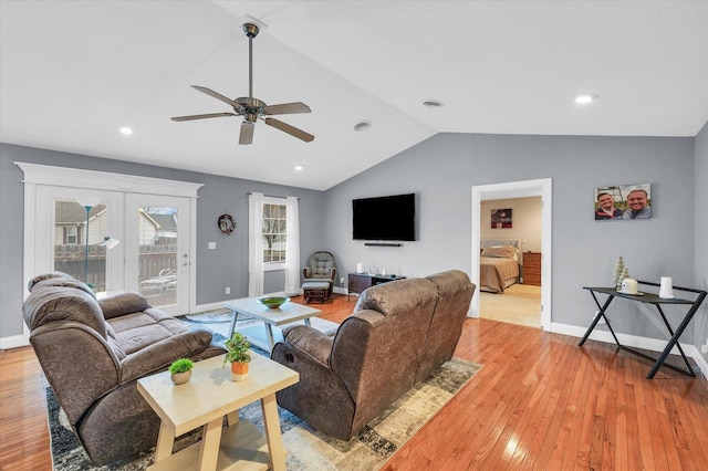 living room with visible vents, baseboards, ceiling fan, light wood-type flooring, and lofted ceiling