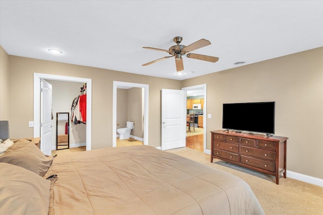 bedroom featuring visible vents, a closet, baseboards, light colored carpet, and a spacious closet