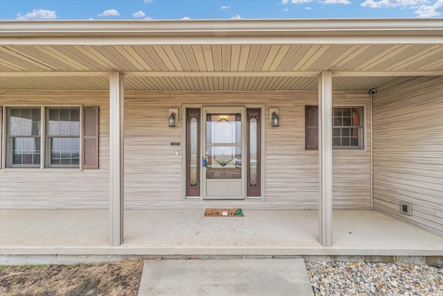 property entrance with covered porch