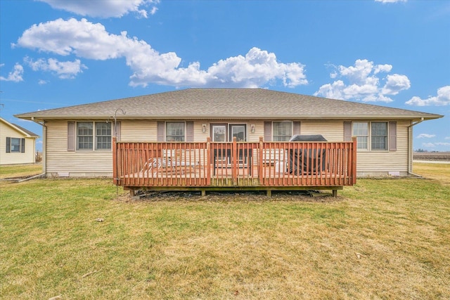 rear view of property with crawl space, a yard, and a wooden deck