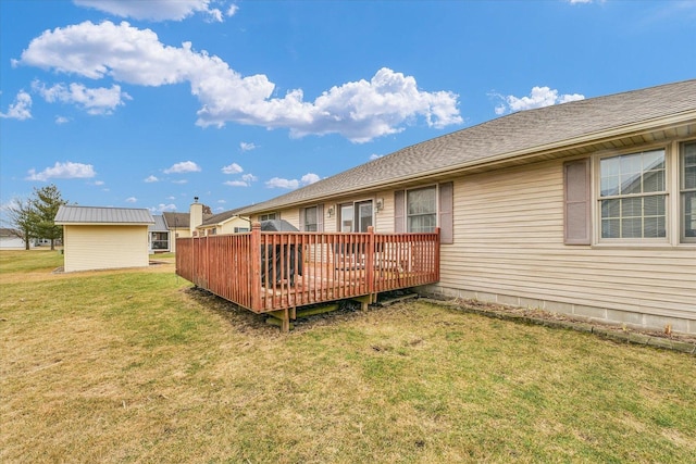 rear view of house with a deck and a lawn