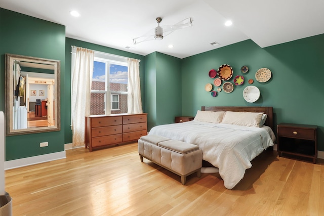 bedroom with light hardwood / wood-style flooring and ceiling fan