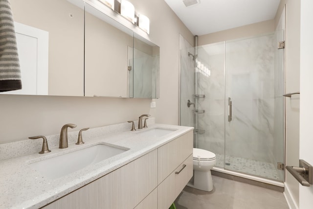 bathroom with tile patterned flooring, vanity, toilet, and walk in shower