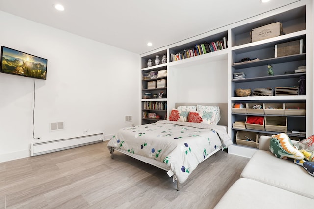 bedroom featuring a baseboard radiator and hardwood / wood-style floors