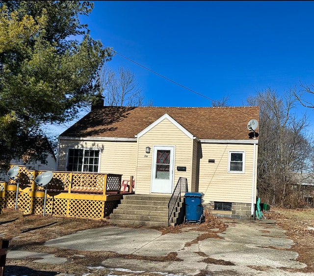 rear view of property with a deck and a patio