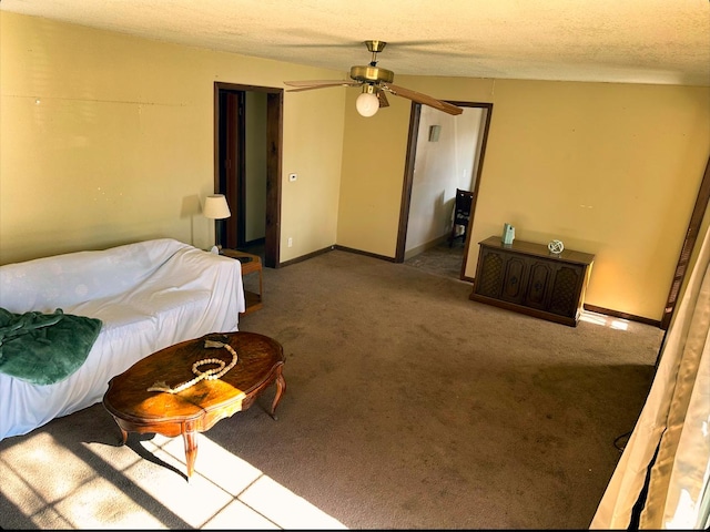 bedroom with a textured ceiling, ceiling fan, and carpet flooring