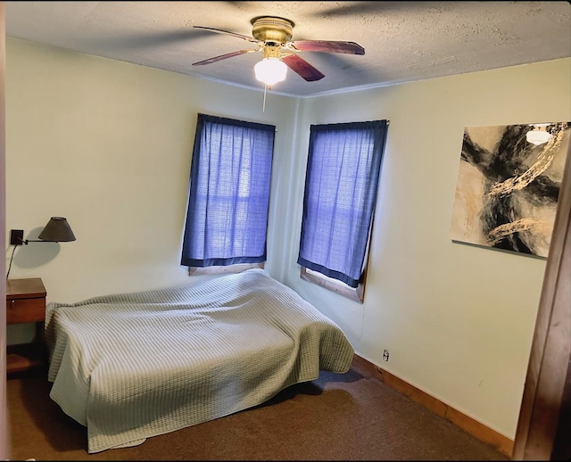 carpeted bedroom featuring a textured ceiling and ceiling fan