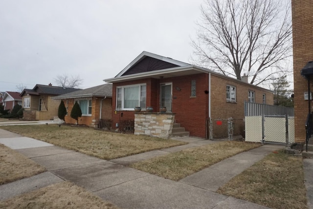 bungalow-style house with a front yard