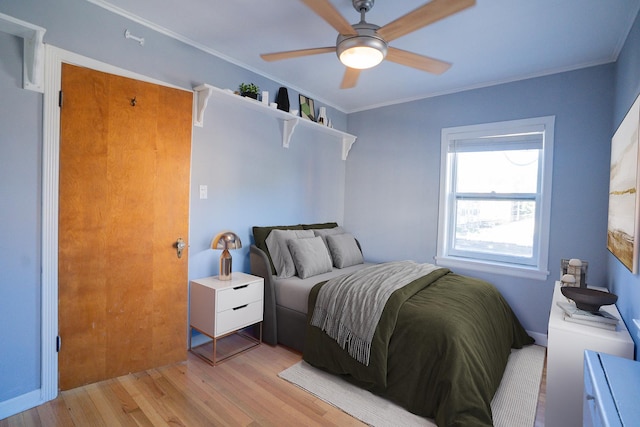 bedroom featuring crown molding, ceiling fan, and light wood-type flooring