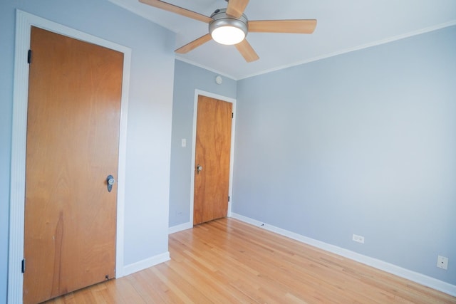 unfurnished bedroom featuring crown molding, a closet, ceiling fan, and light wood-type flooring