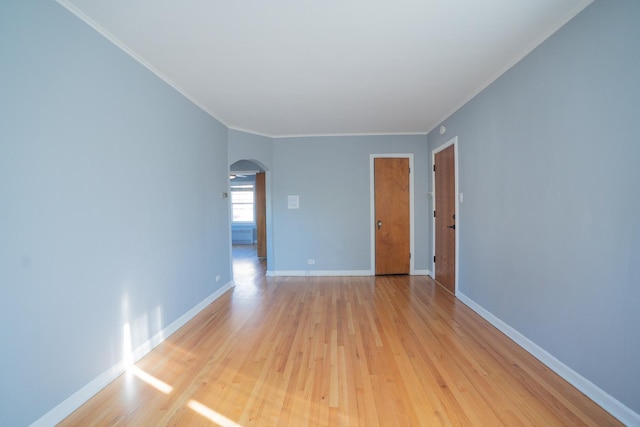 spare room with ornamental molding and light hardwood / wood-style flooring