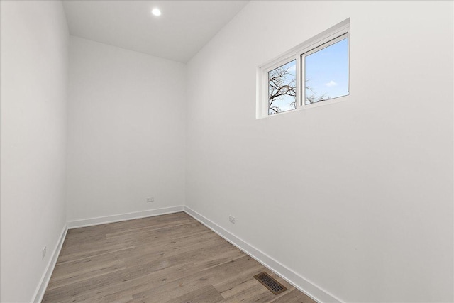 spare room with hardwood / wood-style flooring