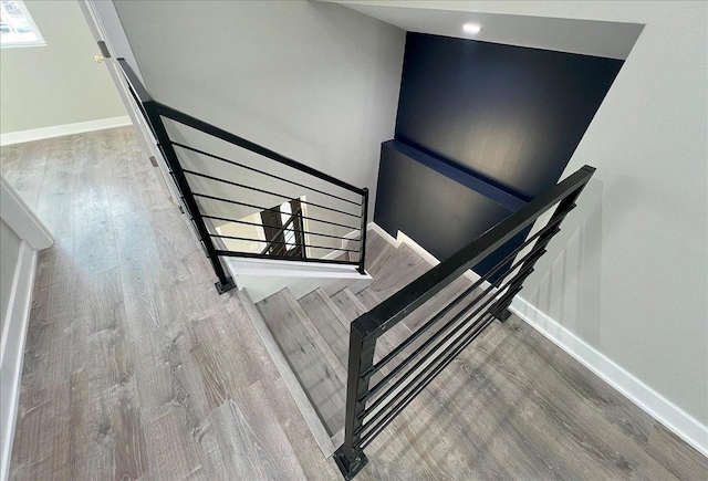 staircase with hardwood / wood-style flooring