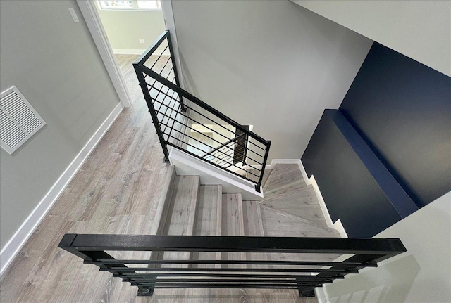 stairs with hardwood / wood-style floors