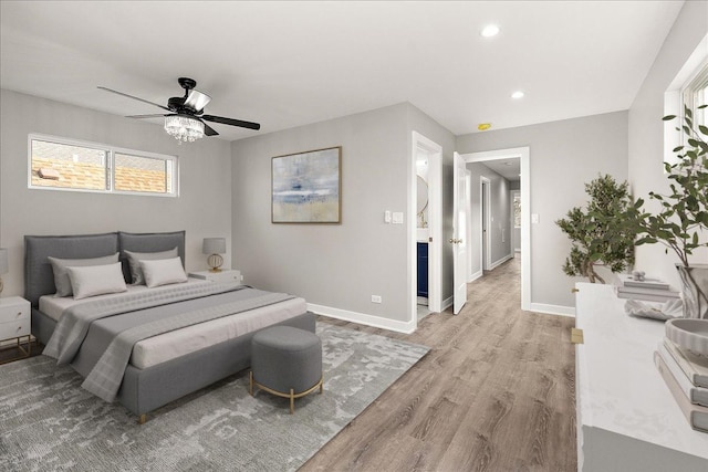 bedroom featuring multiple windows, ceiling fan, and light hardwood / wood-style flooring