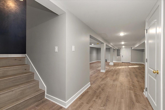 hallway with hardwood / wood-style flooring and electric panel