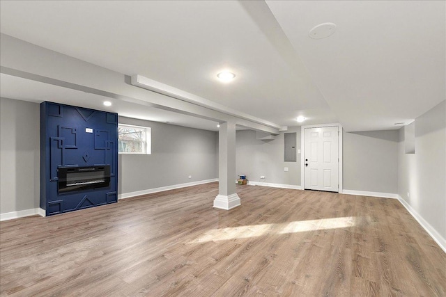 basement featuring wood-type flooring and electric panel