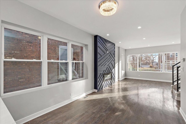 unfurnished living room featuring hardwood / wood-style floors