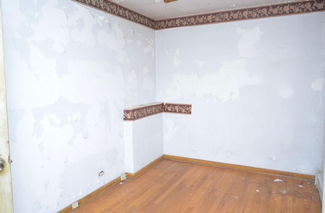 unfurnished room with hardwood / wood-style flooring