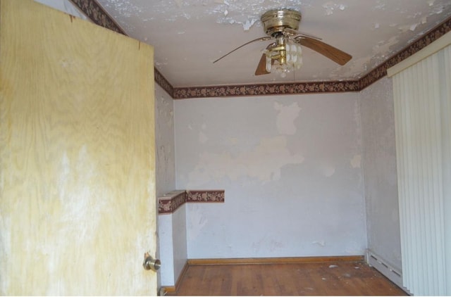 empty room with dark wood-type flooring and ceiling fan