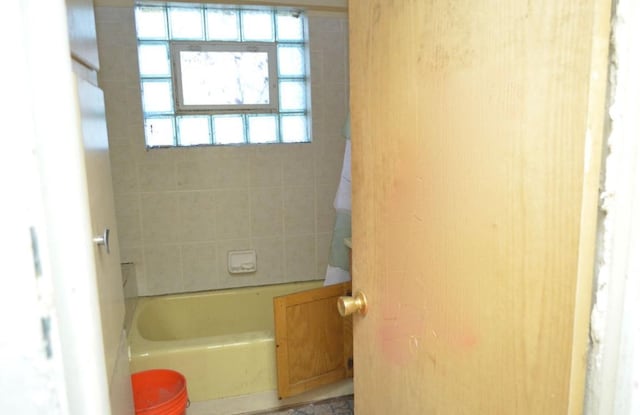 bathroom featuring a tub to relax in