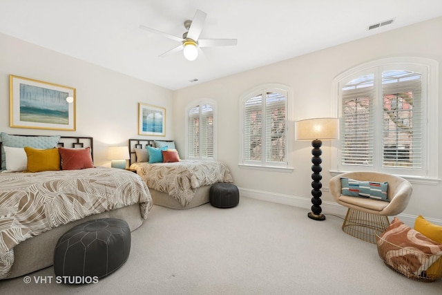 bedroom featuring carpet floors, visible vents, baseboards, and a ceiling fan