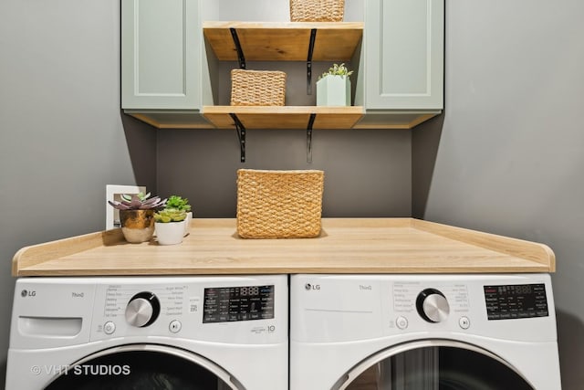 laundry area with cabinet space and independent washer and dryer