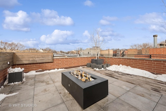 view of patio / terrace with a fire pit and fence