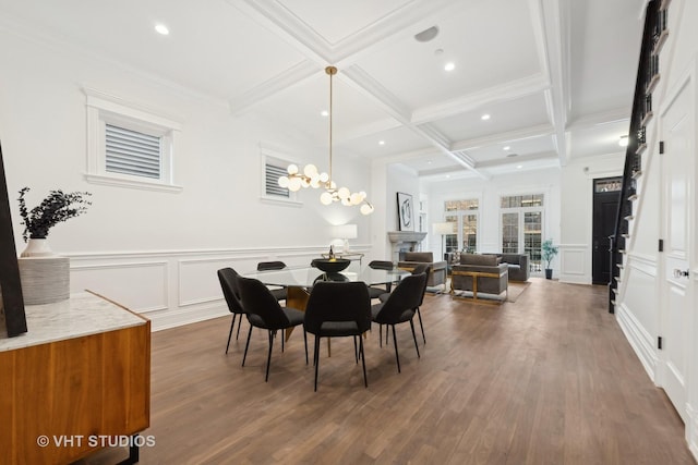 dining space featuring coffered ceiling, dark wood-style flooring, a decorative wall, and beam ceiling