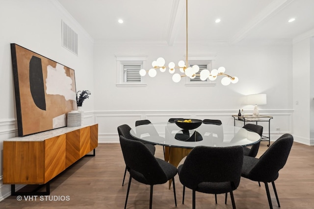 dining area featuring ornamental molding, wood finished floors, and visible vents