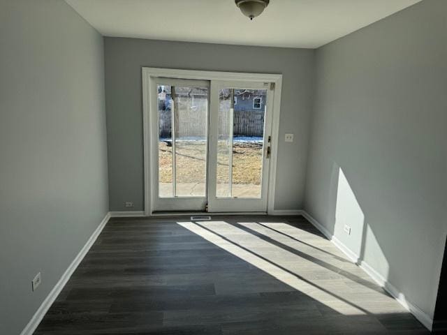 empty room featuring dark hardwood / wood-style flooring