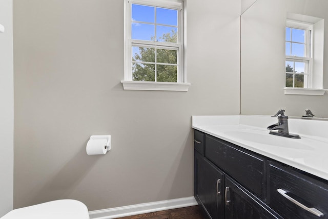 bathroom featuring vanity and toilet