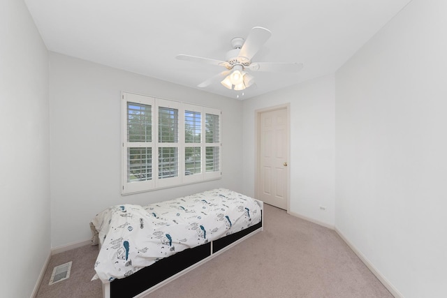 bedroom with light carpet and ceiling fan