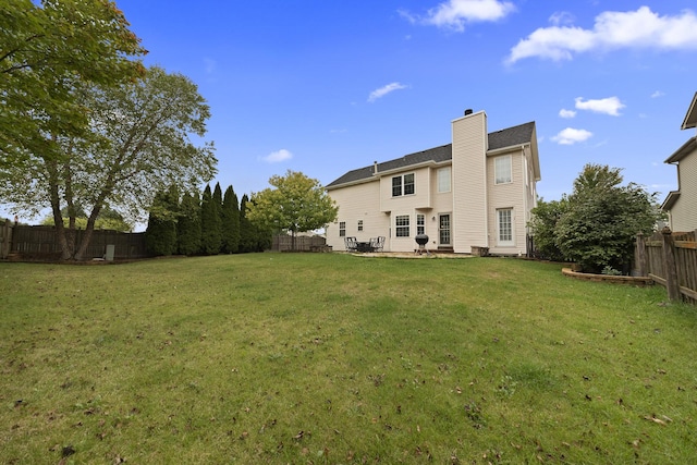 back of property featuring a patio and a yard