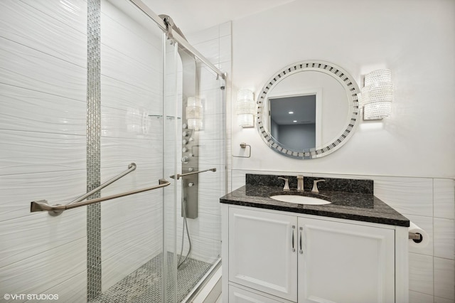 bathroom featuring vanity and an enclosed shower