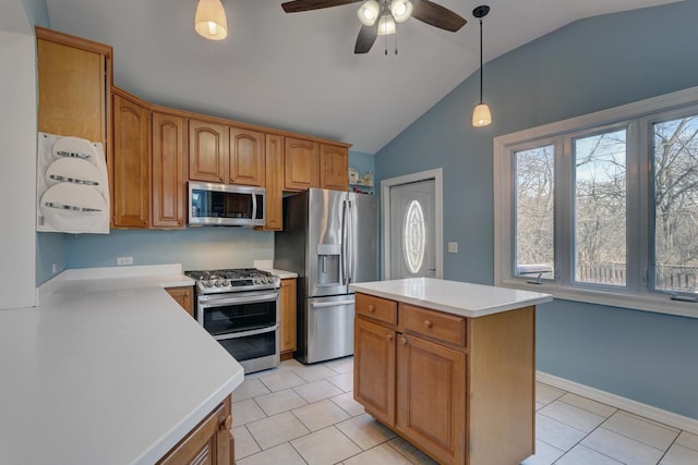 kitchen featuring hanging light fixtures, light tile patterned floors, a center island, and appliances with stainless steel finishes