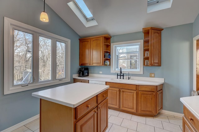 kitchen featuring lofted ceiling with skylight, pendant lighting, sink, a center island, and light tile patterned floors