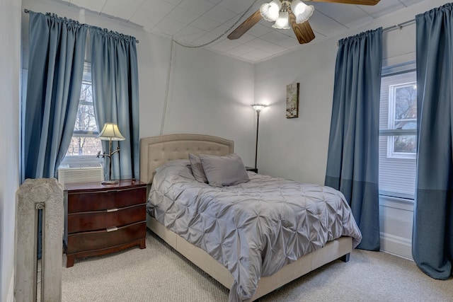 bedroom with carpet flooring, cooling unit, and ceiling fan