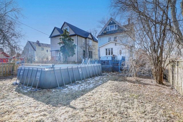 rear view of house with a swimming pool side deck